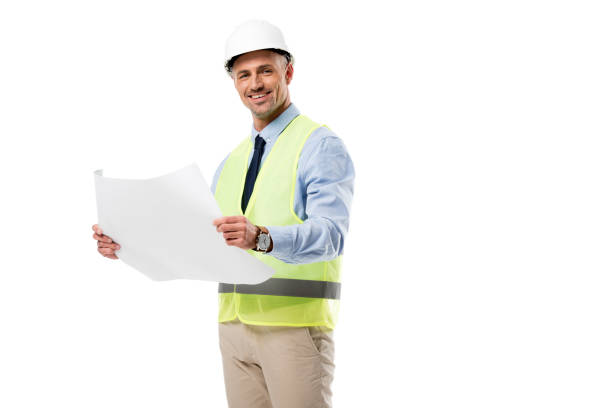 istock handsome engineer in helmet looking at camera and holding blueprint isolated on white 1076666890