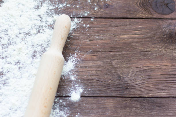 istock white wheat flour and rolling pin on wooden background 1076667036