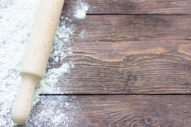 istock white wheat flour and rolling pin on wooden background 1076667166