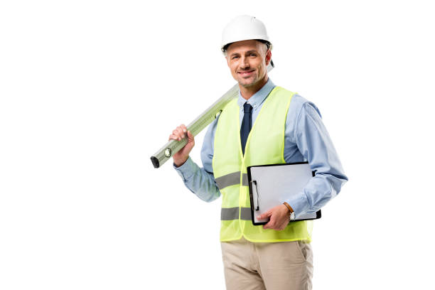 istock smiling engineer holding clipboard and spirit level isolated on white 1076667174