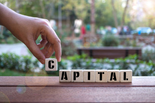 istock CAPITAL Concept with alphabet blocks on wooden table. 1076668868