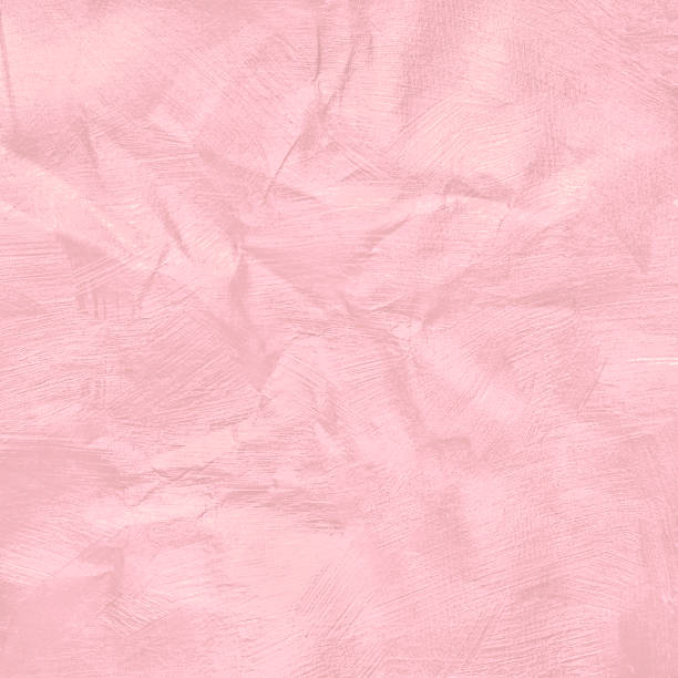 Crumpled pink pastel colour paper texture for background.