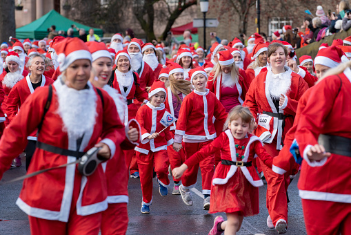 Families take part in the annual Santa Dash, running a 3km course around the centre of Chester.  The event raises money for local charities.
