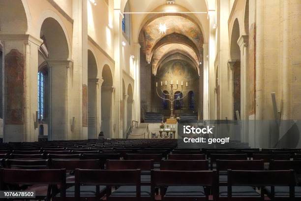Main Room Of The Braunschweig Cathedral With The Colonnades The Altar And The Merciful Chandelier Empty Seating No Church Service Stock Photo - Download Image Now