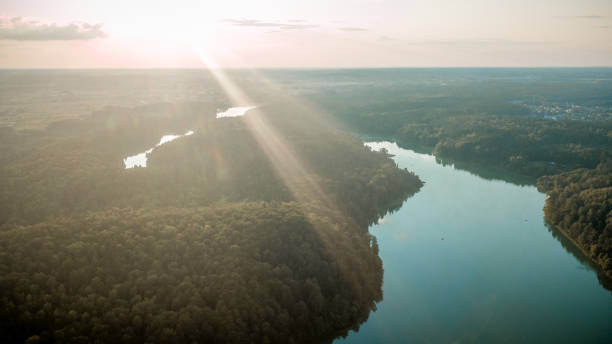 istock Drone view of forest and lake during sunset. 1076678944