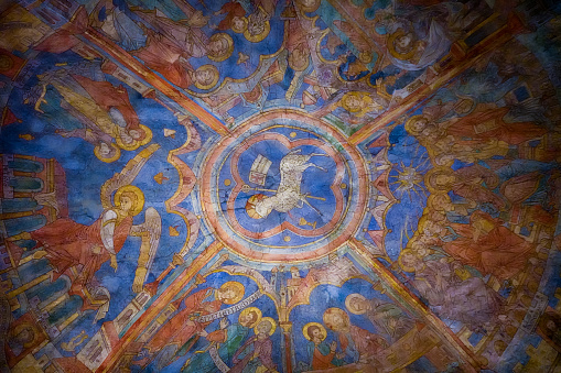 Colourful medieval painting on the ceiling of the main nave in Braunschweig Cathedral, with the peaceful sheep of Jesus in the centre.