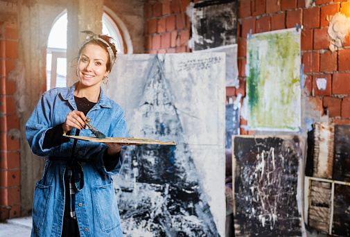 Young woman as artist at her studio