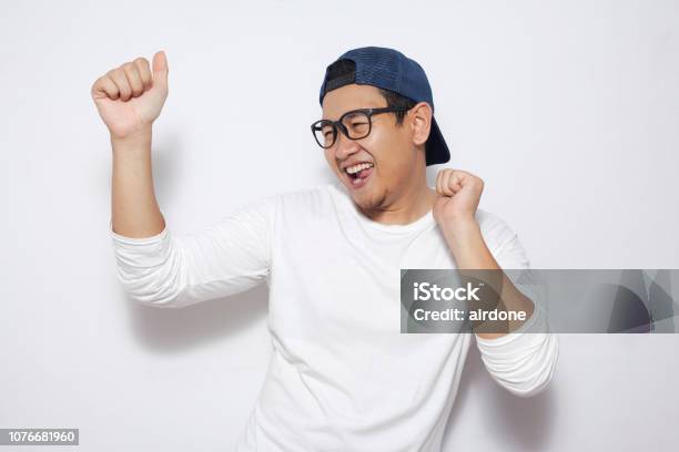 Happy Funny Asian Man Dancing Full Of Joy Stock Photo - Download Image Now - Men, Happiness, Dancing