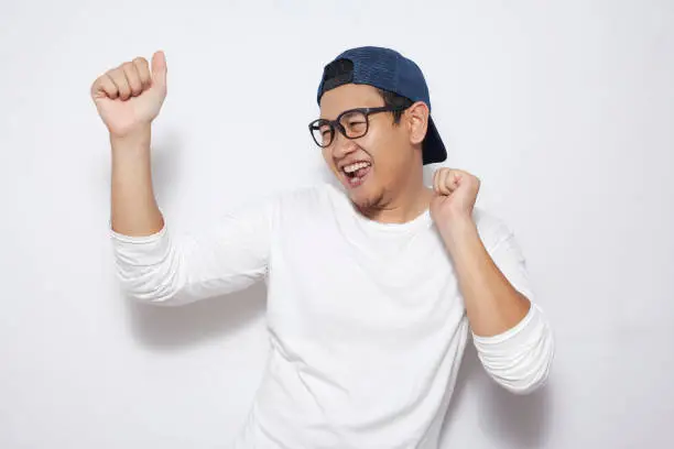 Photo of Happy Funny Asian Man Dancing Full of Joy