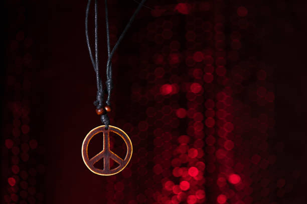 istock Wooden peace symbol with red lights background 1076682780