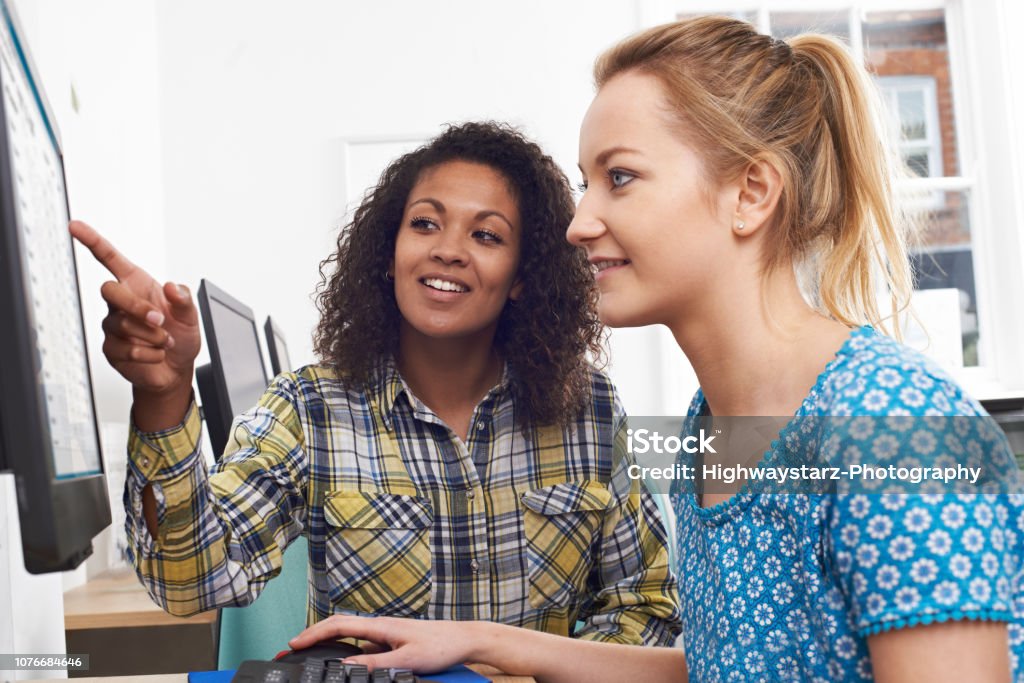 Businesswoman Giving Computer Training In Office Trainee Stock Photo