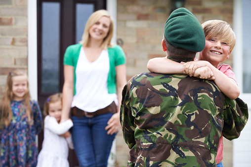 Hijo saludo militar padre de permiso en el hogar photo