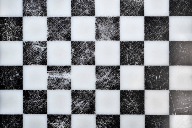 istock Old chessboard on top. Black and white texture with scratches. 1076686570