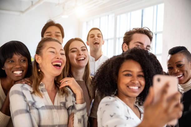 istock Happy office people taking a selfie after work 1076690030