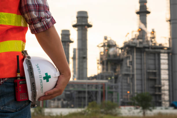 istock engineer holding white helmet for workers security on background of power plant on background 1076691086