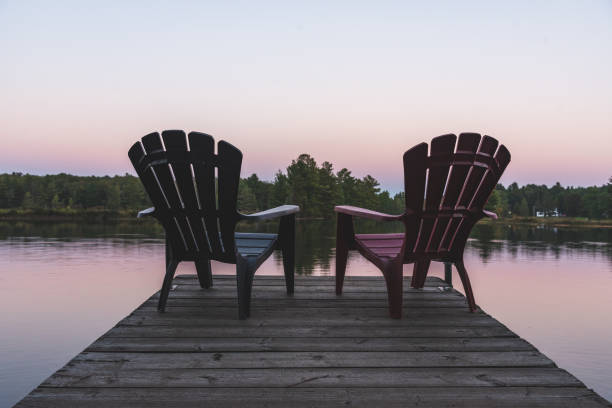 istock Two Adirondack chairs sitting on a dock - Muskoka, Ontario, Canada. 1076691982