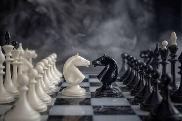 istock Knight Chess battle on dark background , selective focus. Chess knights head to head. 1076695600