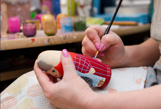 el artista dibuja una muñeca matryoshka. primer plano de la mano - russian nesting doll skill doll russia fotografías e imágenes de stock