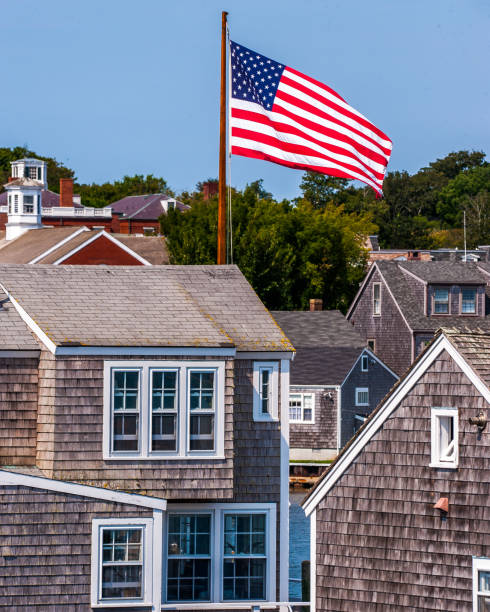 istock Homes in Nantucket Harbor with the American flag 1076709936