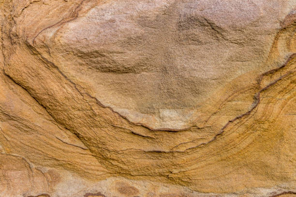 istock Sandstone wall, sandstone with artistic patterns hatching relief-like shapes on the surface, detail shot 1076720608