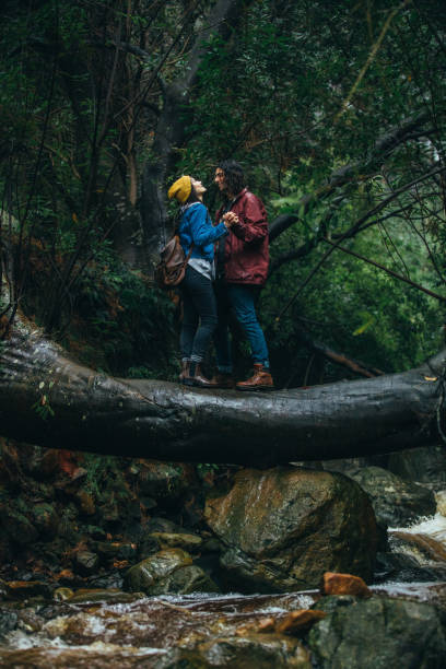istock Couple enjoying in rain at the forest 1076723774