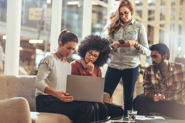 istock Business colleagues looking at a laptop in office 1076725966