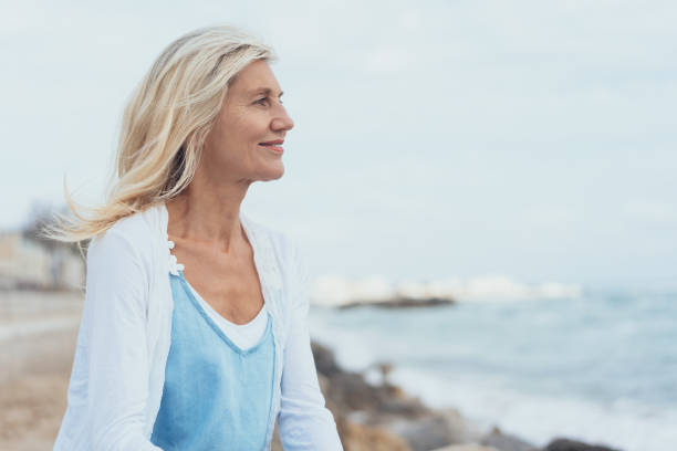 istock Attractive middle-aged blond woman at the seaside 1076726162
