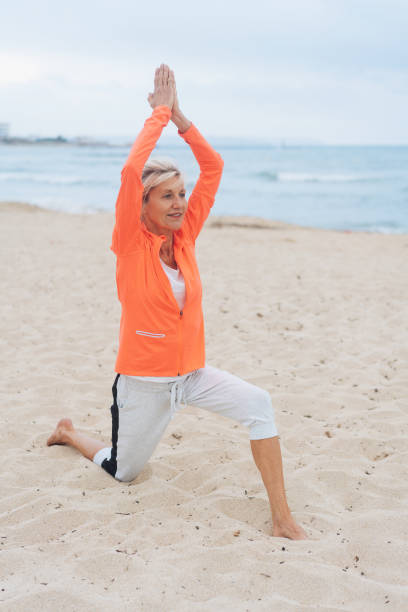 istock Fit healthy woman working out on a sandy beach 1076727794