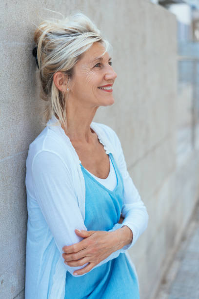 istock Smiling relaxed blond woman with folded arms 1076728986