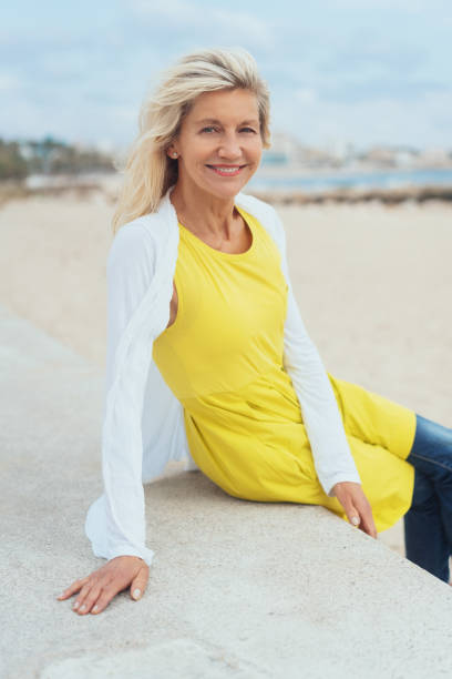 istock Trendy older blond woman at the beach 1076732116