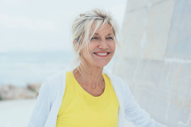 istock Middle-aged smiling woman with yellow blouse 1076732616