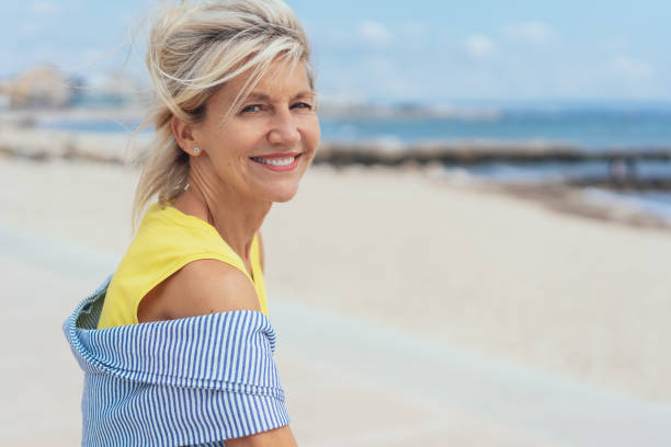 istock Trendy blond woman on a sandy beach 1076734520