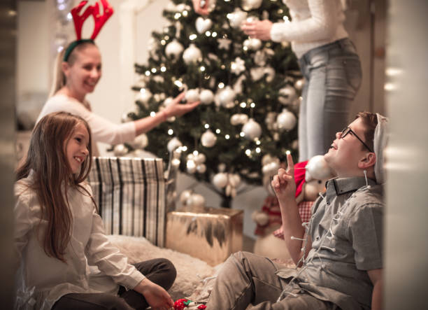 istock Having fun with kids in front of Christmas tree 1076738092