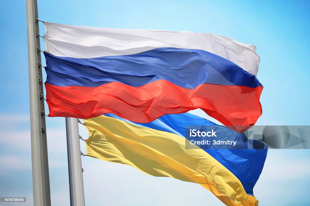 Flag of Russia and Ukraine Flag of Russia and Ukraine against the background of the blue sky Russia Stock Photo