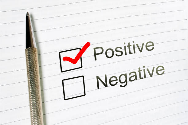 istock questionnaire: positive choice or negative, marked check box with a pen on lined paper background. Approval concept 1076741388