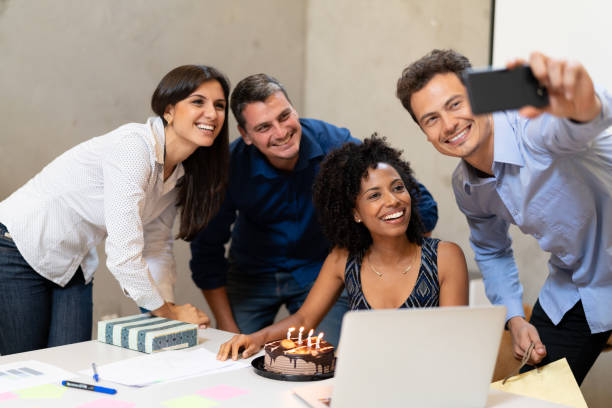 istock Business colleagues taking a selfie at birthday party at work 1076745192