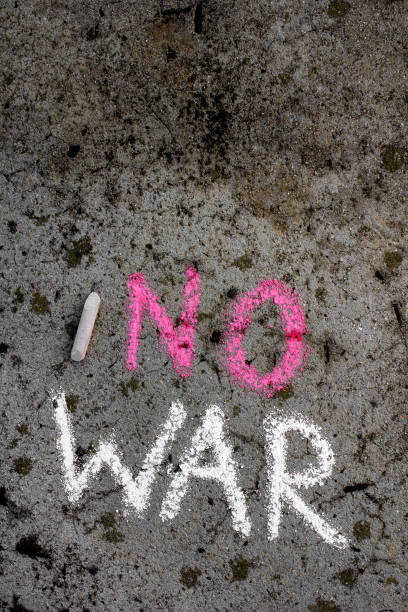 istock Colorful chalk drawing on asphalt: Words NO WAR 1076751332