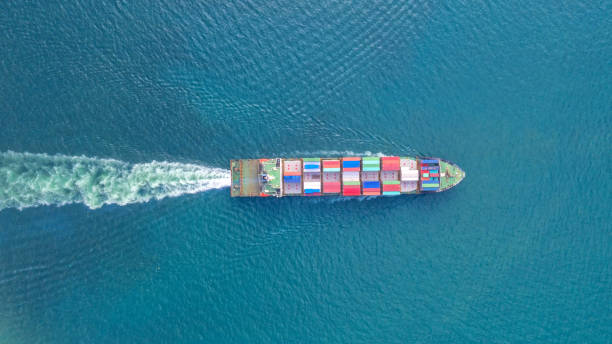 istock Container ship in export and import business and logistics. Shipping cargo to harbor by crane. Water transport International. Aerial view and top view. 1076755244