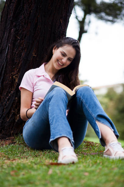 istock Woman reading in the park 1076759356