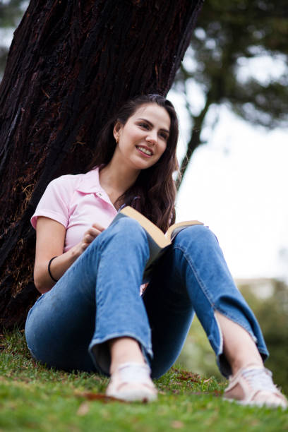 istock Woman reading in the park 1076759772