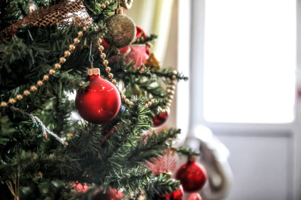 istock glass ball and decorations on Christmas tree 1076759846