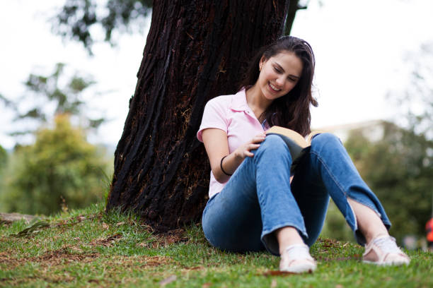 istock Woman reading in the park 1076759956