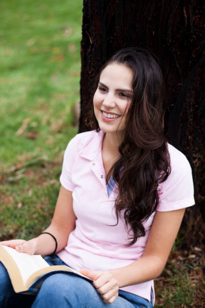 istock Woman reading in the park 1076760590