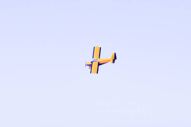 istock A yellow plane with a propeller on the blue sky 1076770942