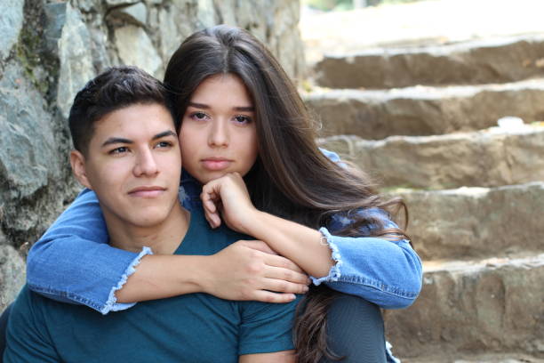 istock Evil looking girlfriend holding boyfriend tight 1076771510