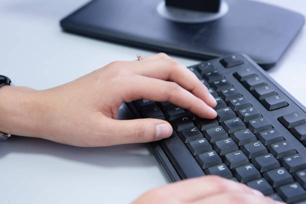istock Female office worker typing on the keyboard 1076772226