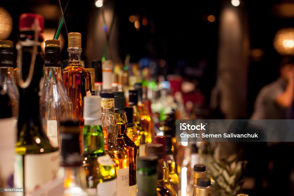 Bottles of spirits and liquor at the bar Happy Hour Stock Photo