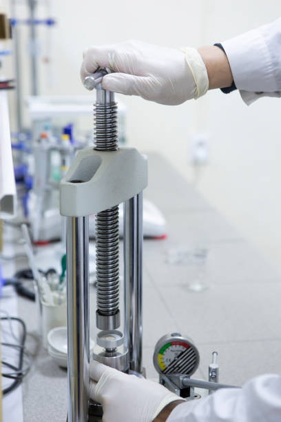 istock Serious clinician studying chemical element in working environment 1076777206