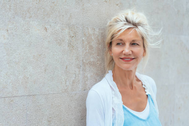 istock Thoughtful woman standing watching to the side 1076780630