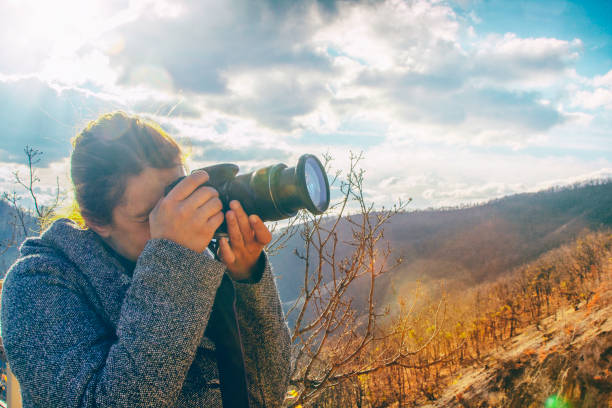 istock Female professional photographer in nature 1076781288